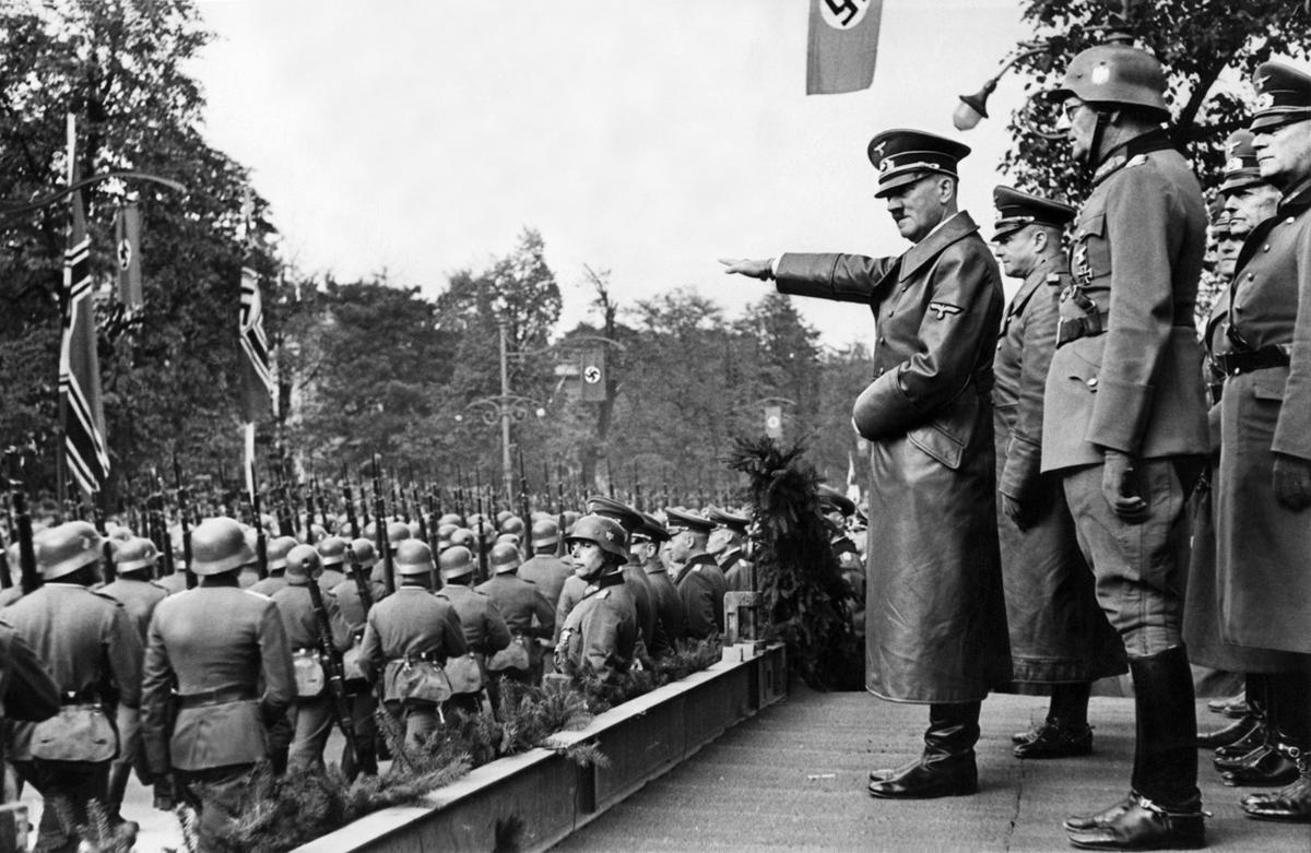 Hitler watching German soldiers marching into Poland in 1939 CE